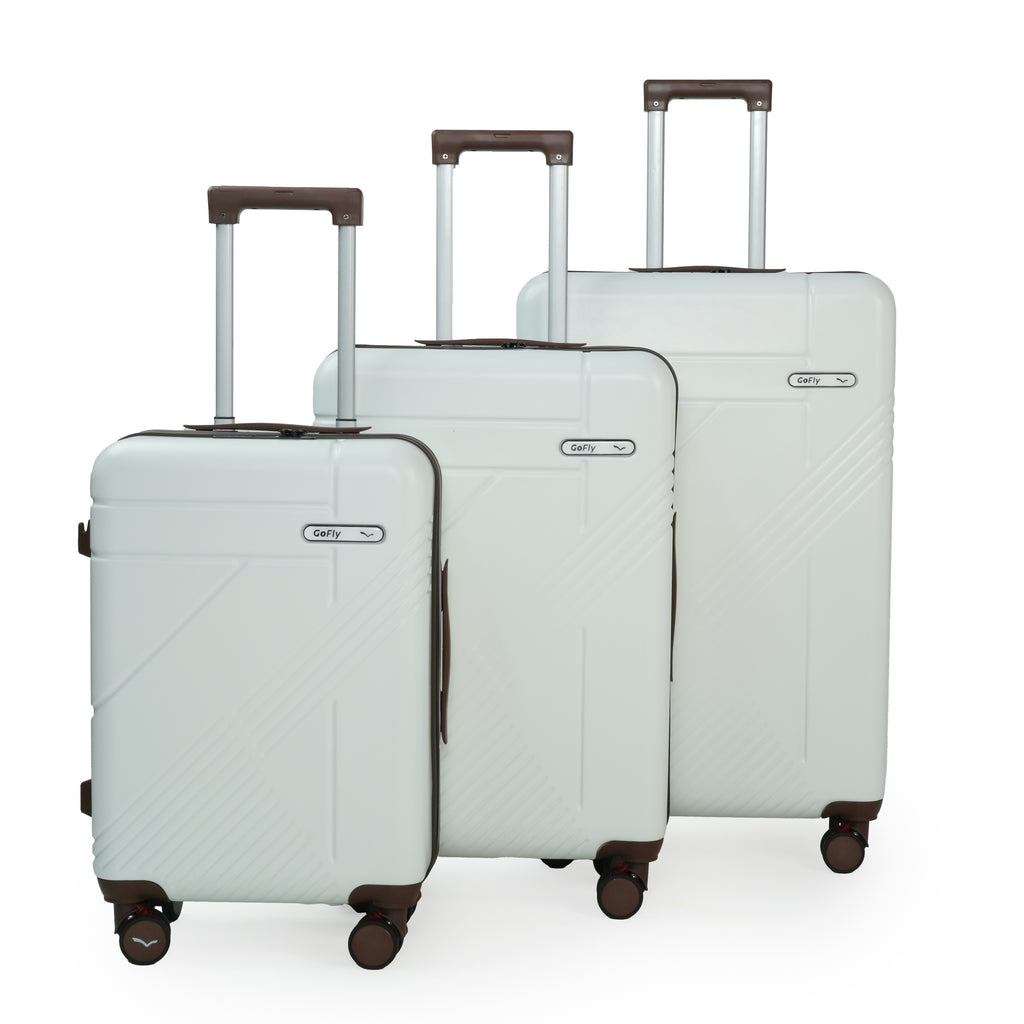 Set of three white suitcases with wheels on a white background