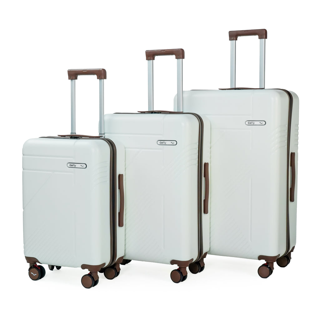 Set of three white suitcases with brown handles and wheels on a white background