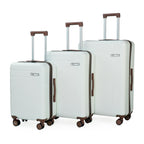 Set of three white suitcases with brown handles and wheels on a white background