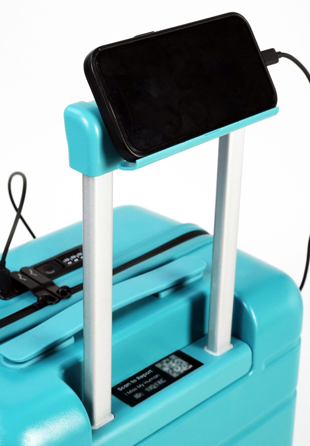 Turquoise suitcase with a phone on top and charging cable, on a white background