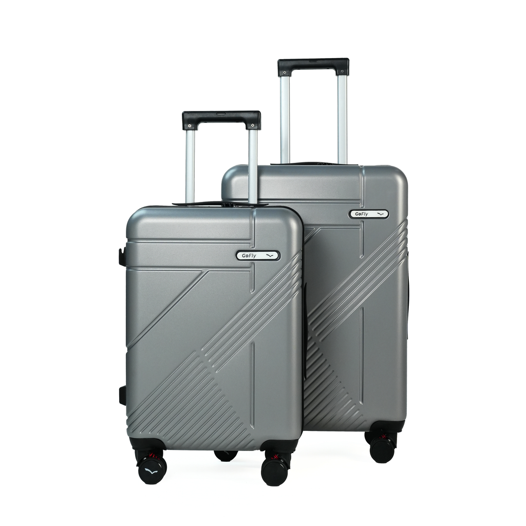 Two silver suitcases with wheels on a white background