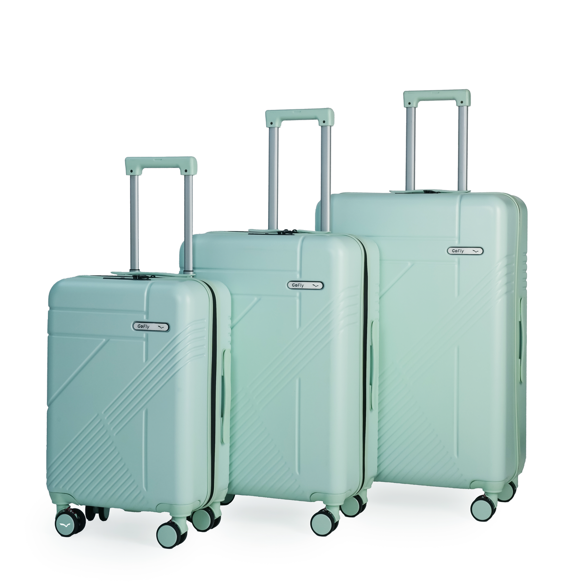 Set of three light green suitcases with wheels on a white background